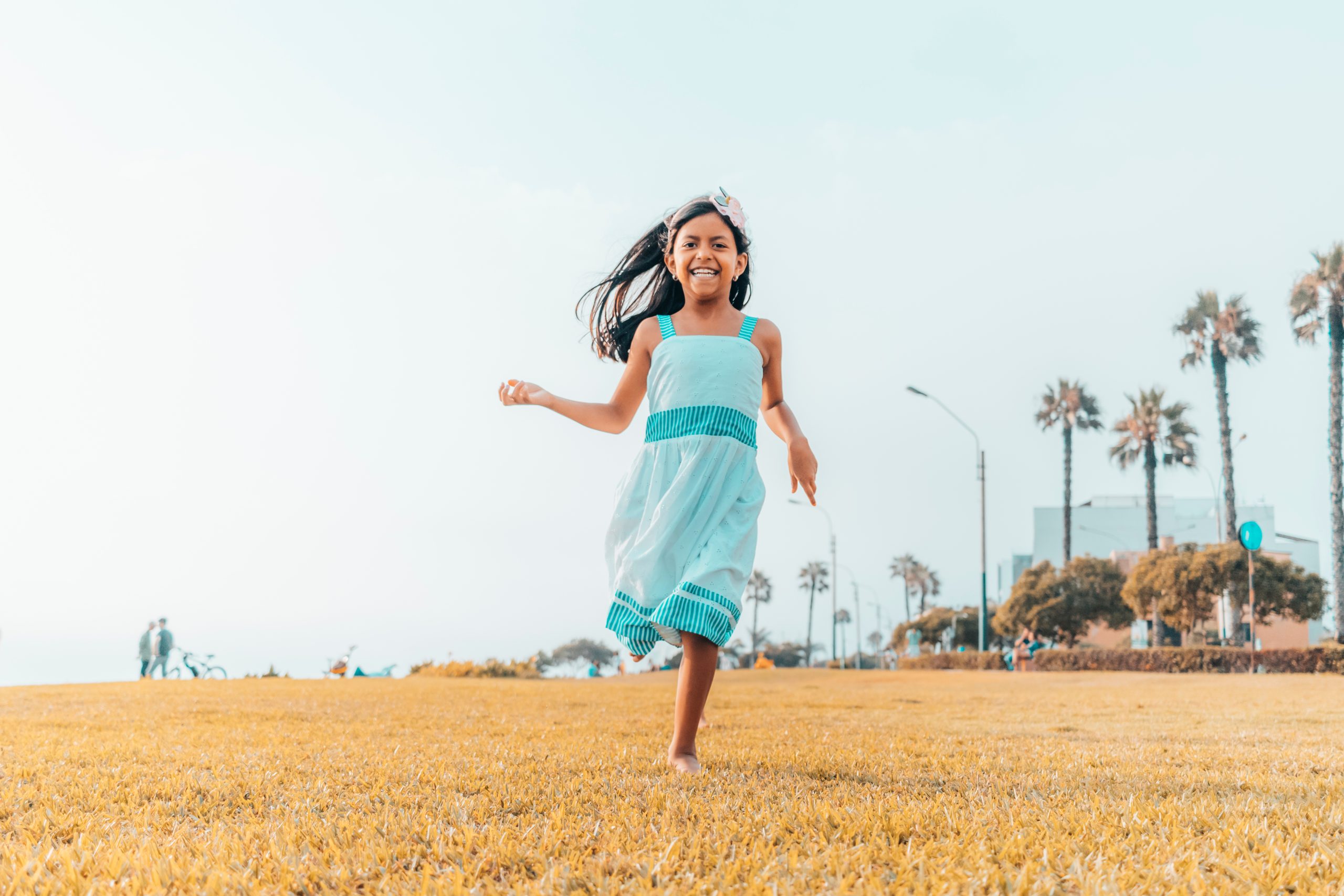 Cute little girl running freely on the grass